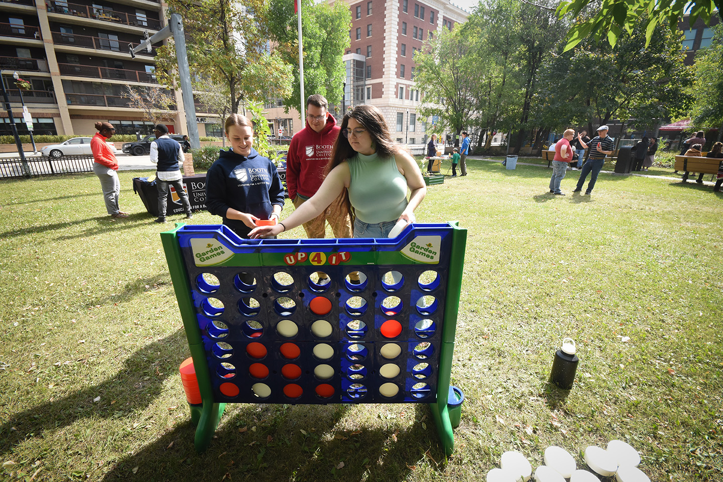 Students play a jumbo-sized game on the campus lawn during an event.
