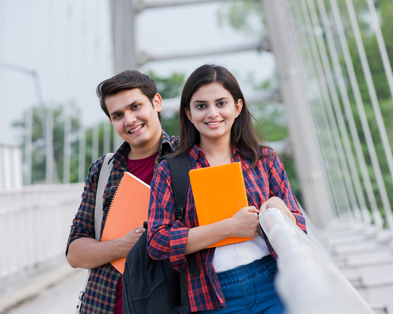 two-university-students-holding-books